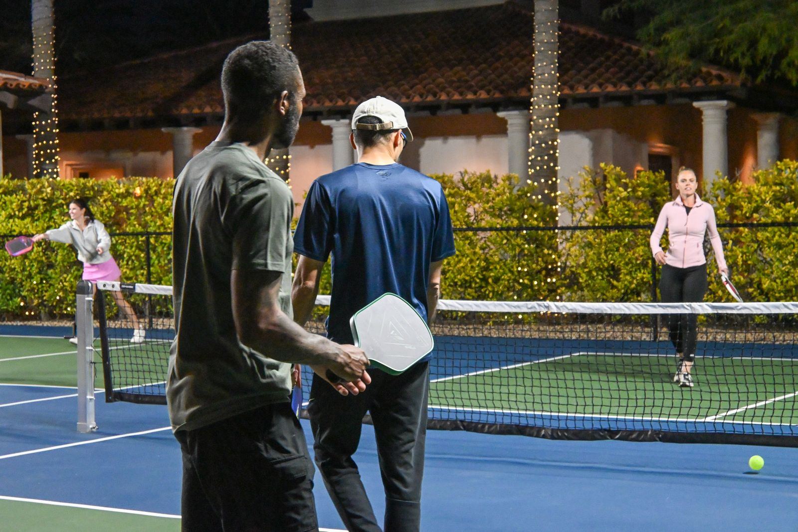 Recreational doubles match under the lights